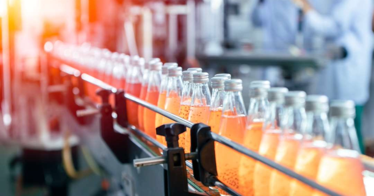 Featured image of a row of apple juice bottles in a facility