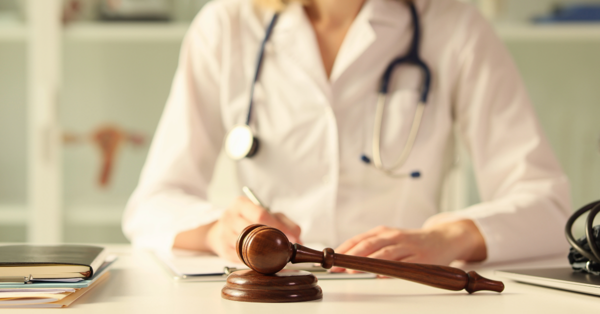 Doctor sitting in front of a gavel and block